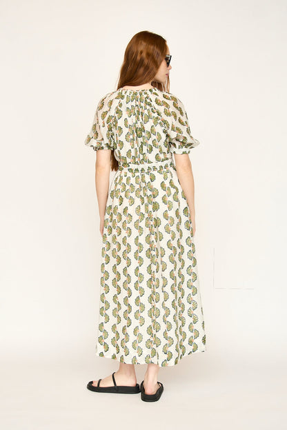 Green cotton maxi dress on a hanger in store