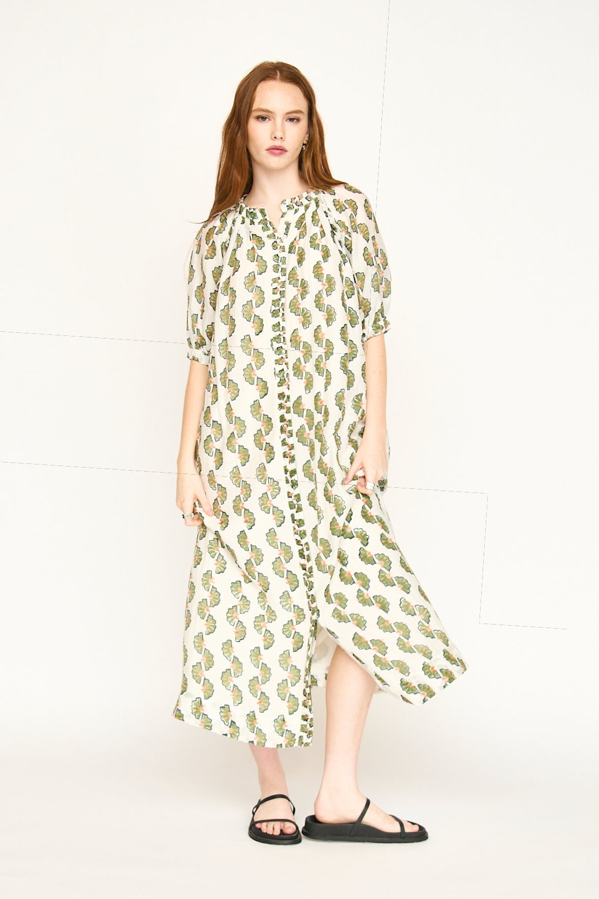 Green cotton maxi dress on a hanger in store