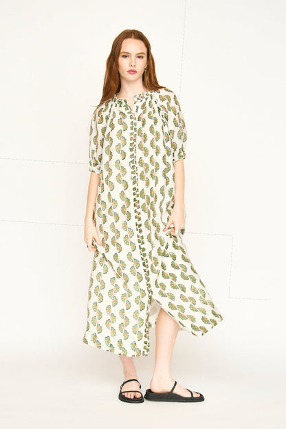 Green cotton maxi dress on a hanger in store