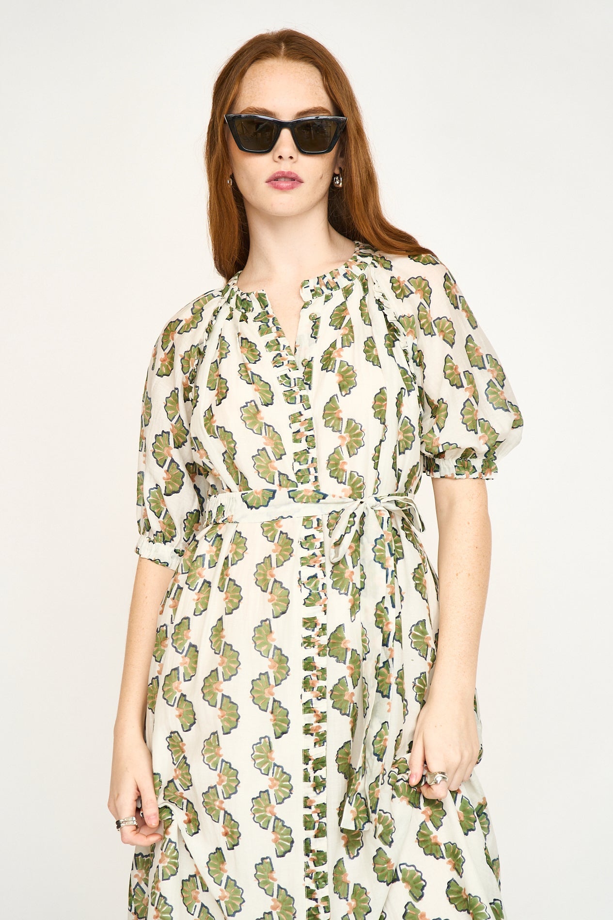 Green cotton maxi dress on a hanger in store