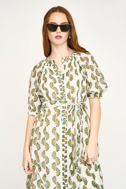 Green cotton maxi dress on a hanger in store
