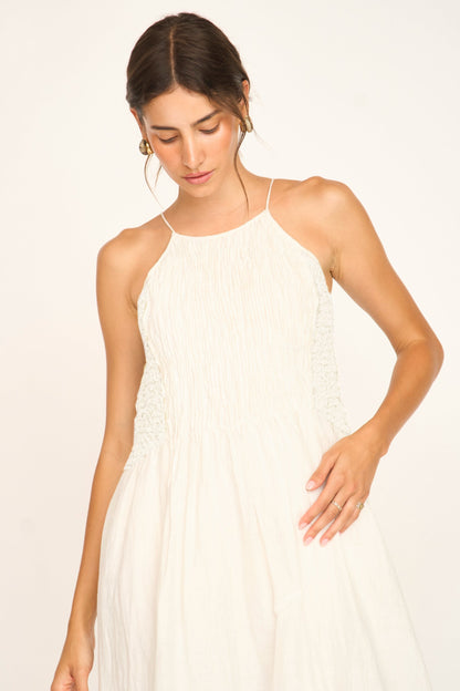 White linen smocked dress on a hanger in store