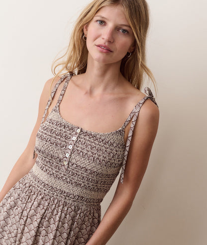 Brown smocked dress on a hanger in store