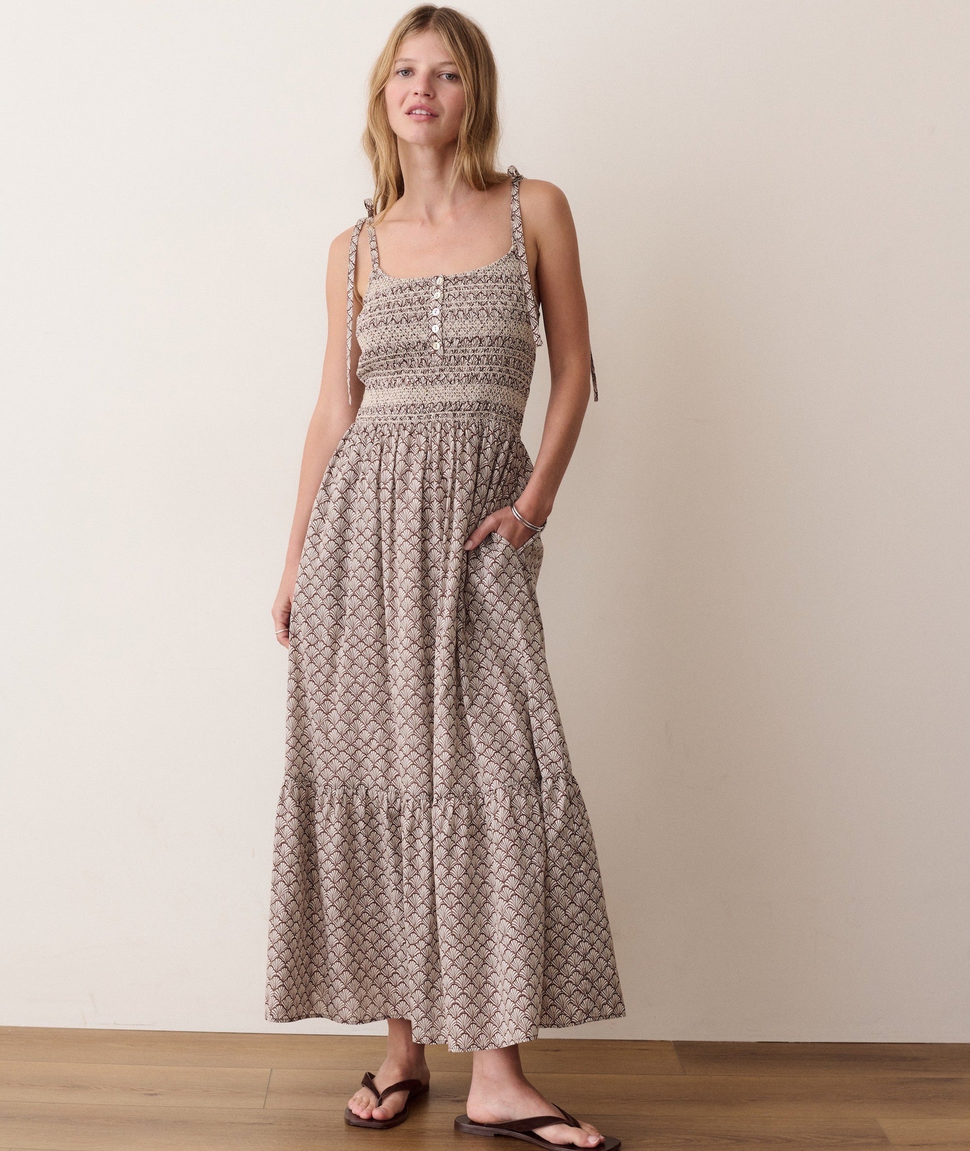 Brown smocked dress on a hanger in store