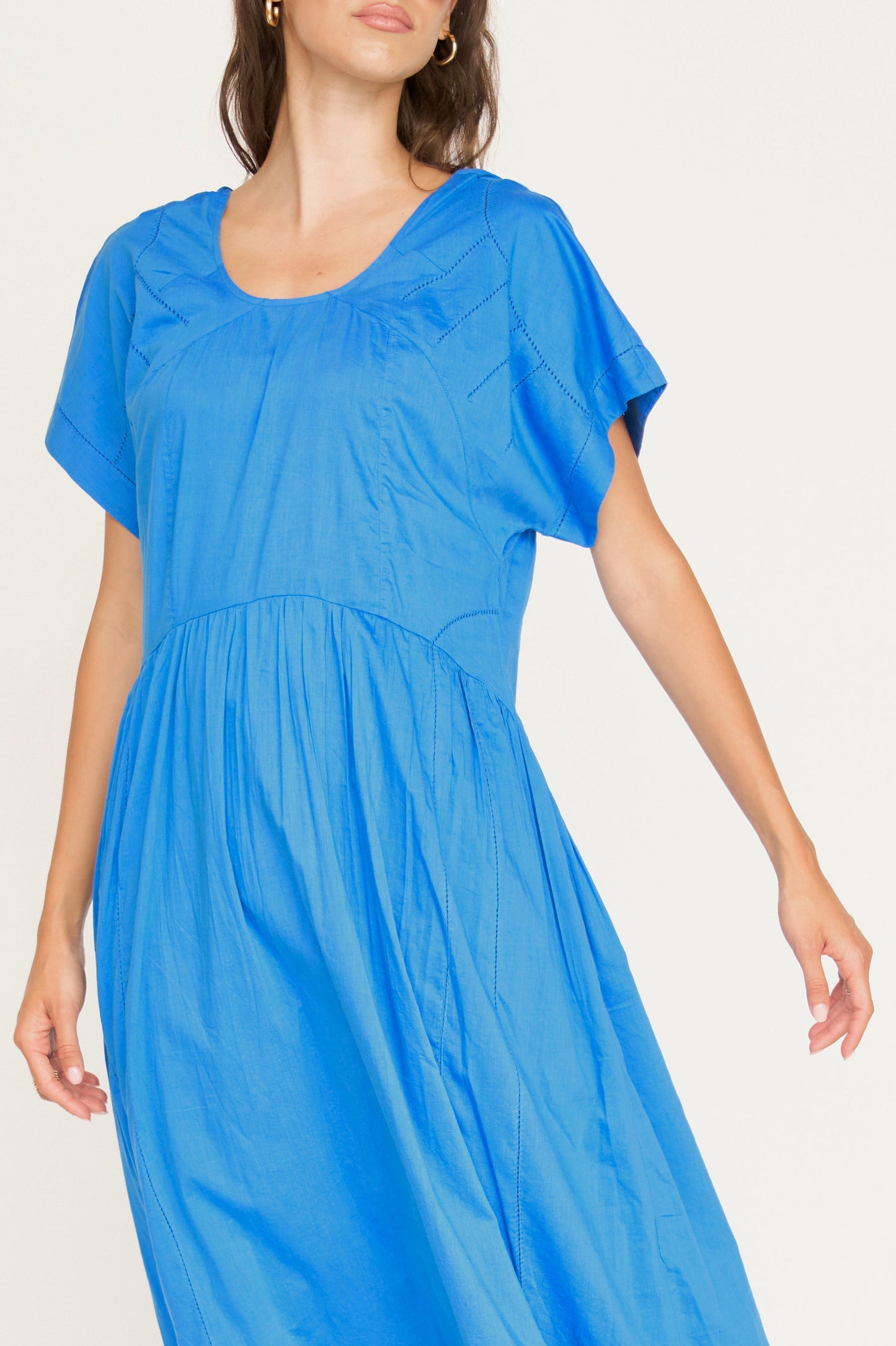 Blue cotton dress on a hanger in store