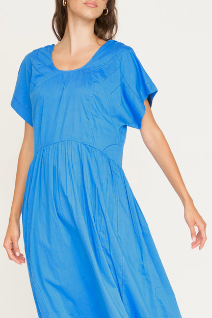 Blue cotton dress on a hanger in store