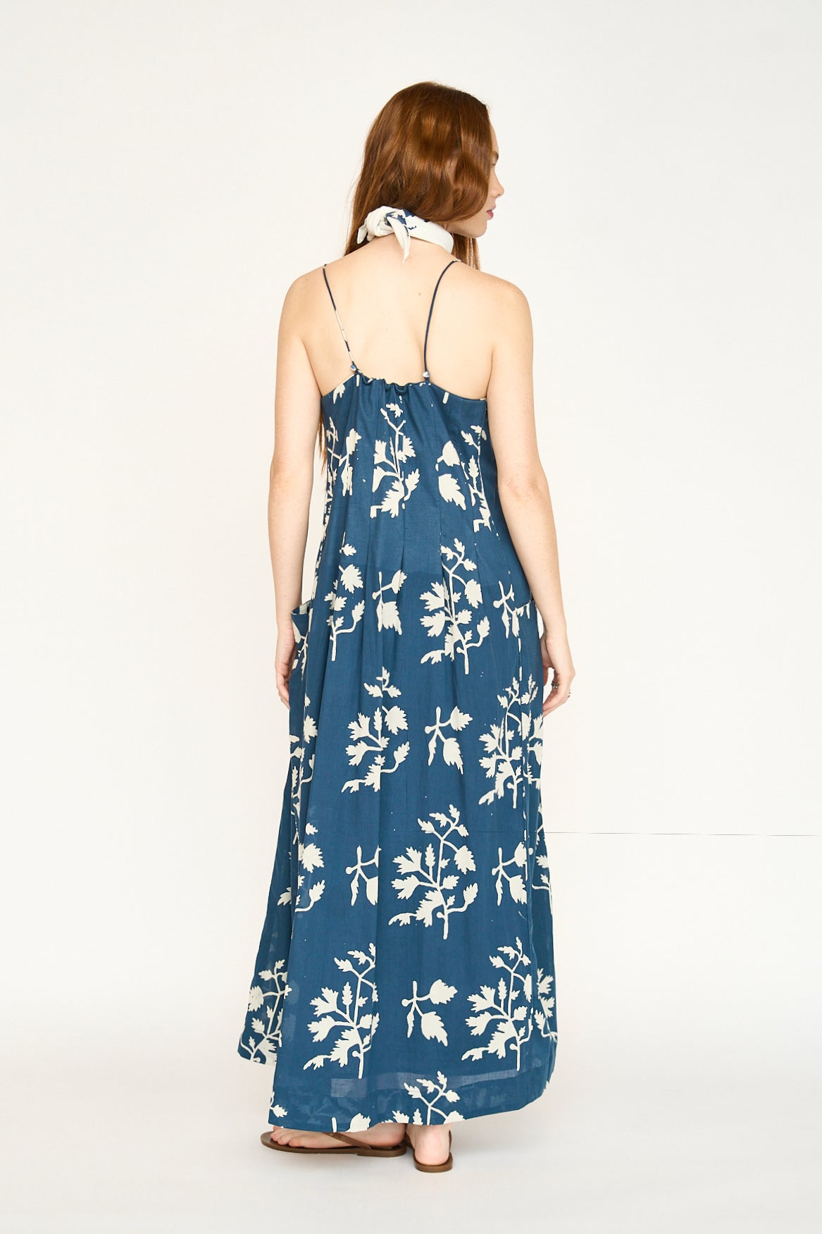 Blue cotton maxi dress on a hanger in store