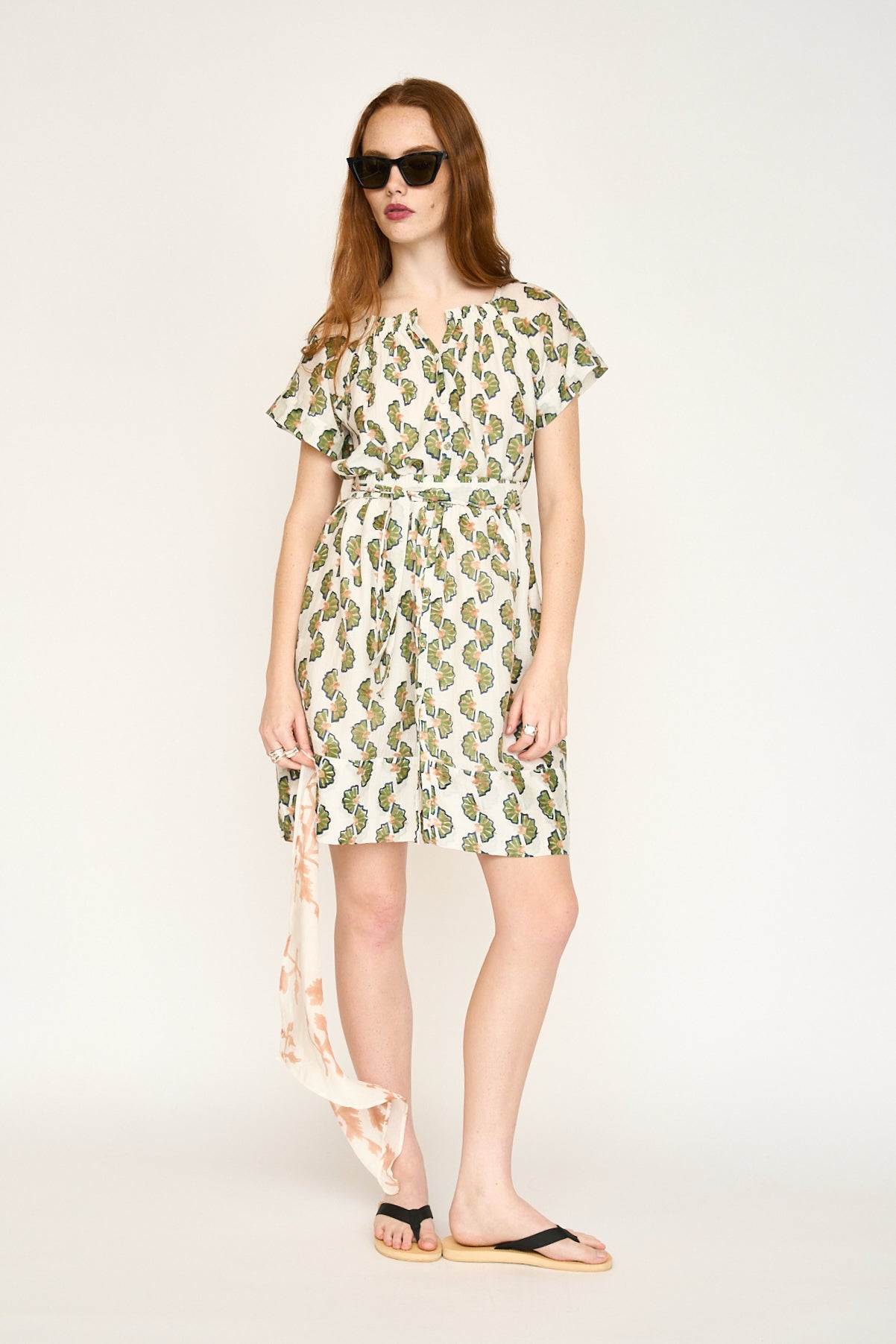 Green cotton short dress on a hanger in store