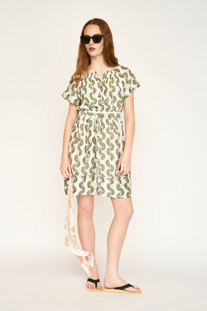Green cotton short dress on a hanger in store