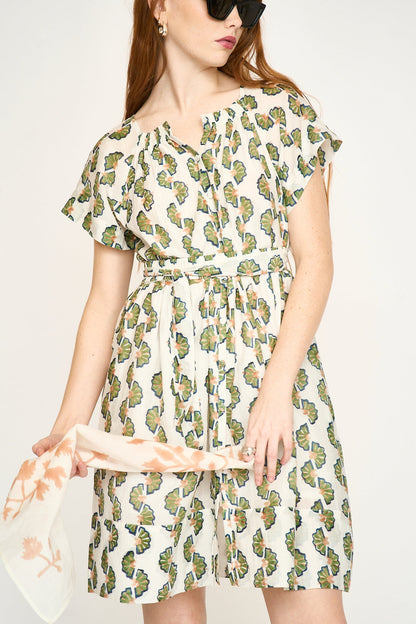 Green cotton short dress on a hanger in store