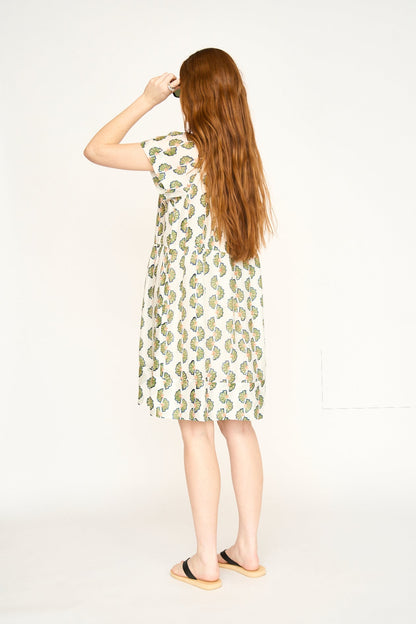 Green cotton short dress on a hanger in store