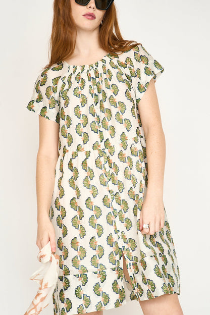 Green cotton short dress on a hanger in store