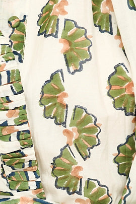 Green cotton short dress on a hanger in store