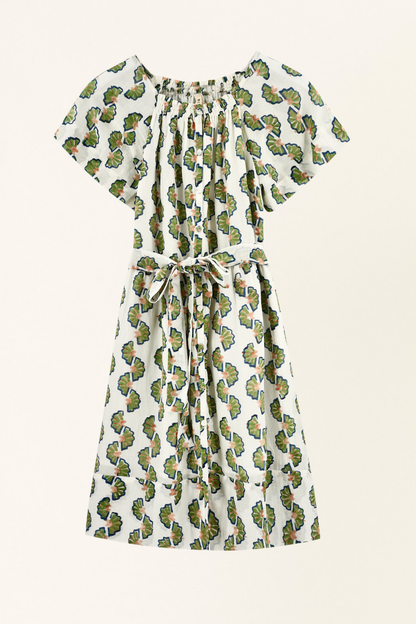 Green cotton short dress on a hanger in store