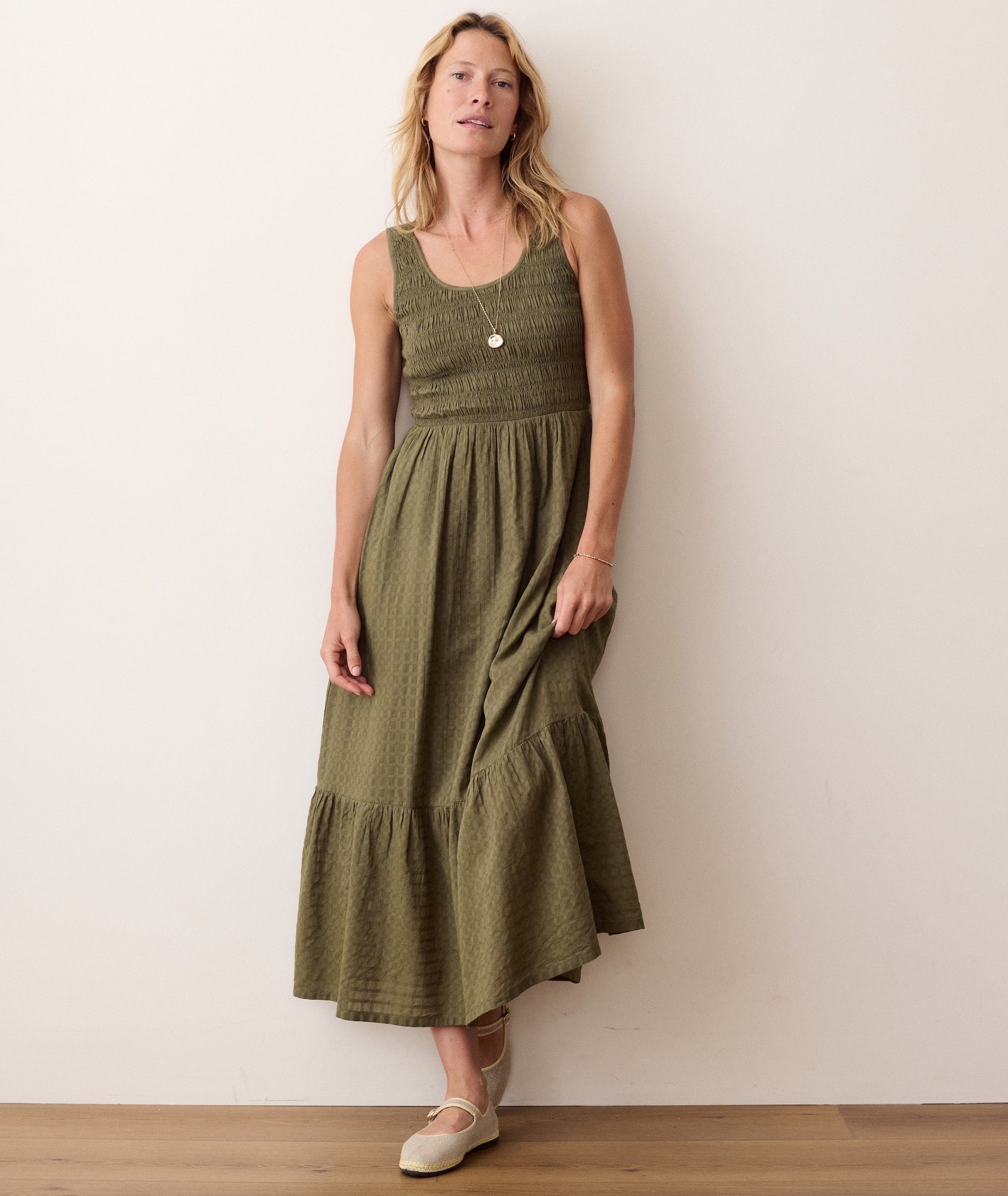 Green midi dress on a hanger in store