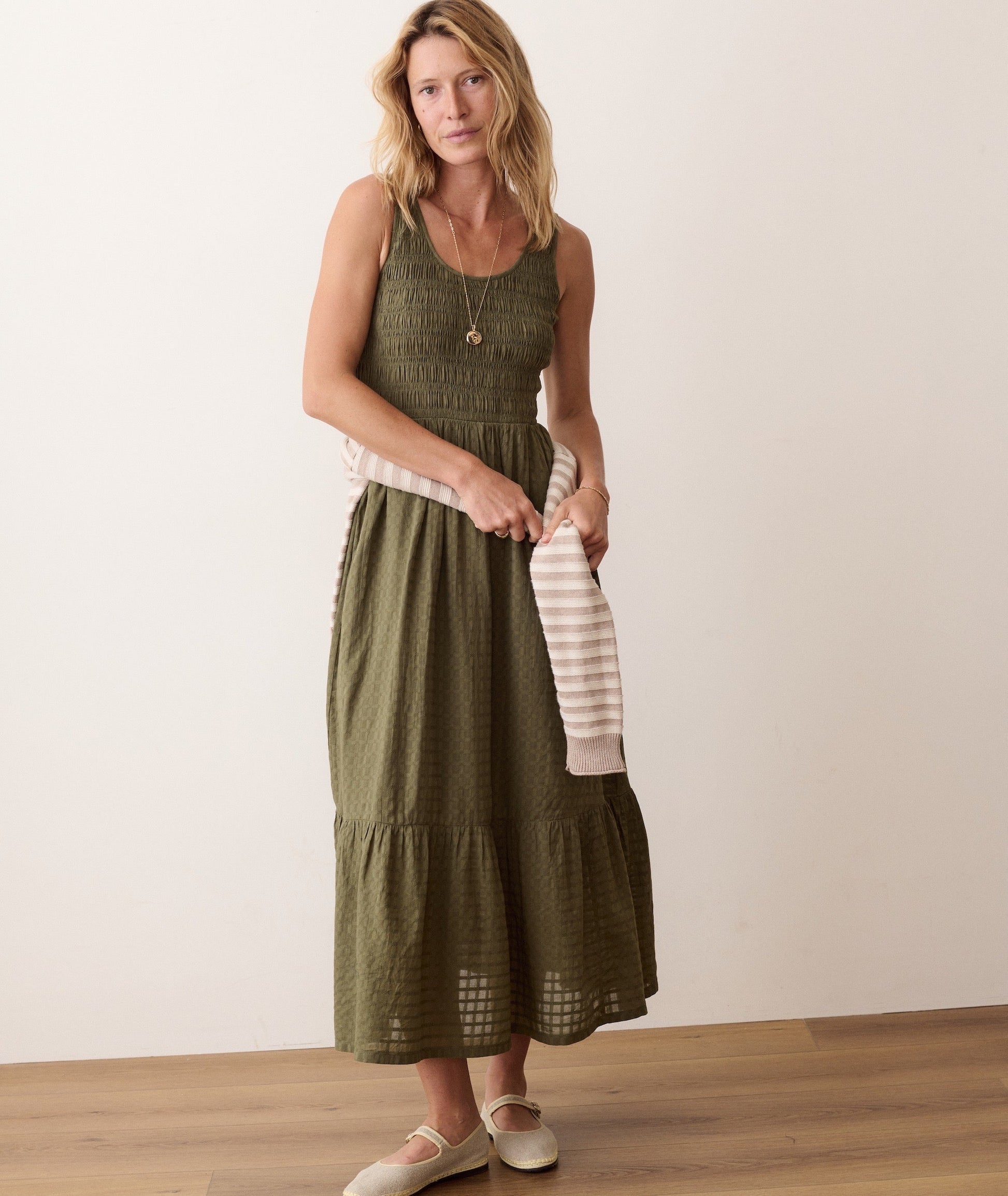 Green midi dress on a hanger in store