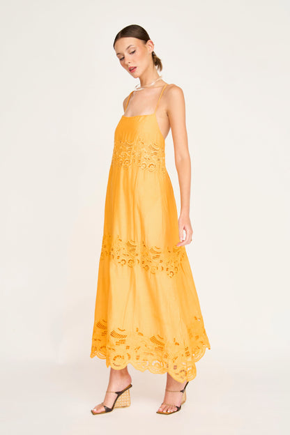 Yellow cotton maxi dress on a hanger in store