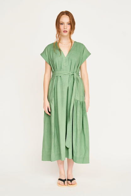 Green cotton midi dress on a hanger in store