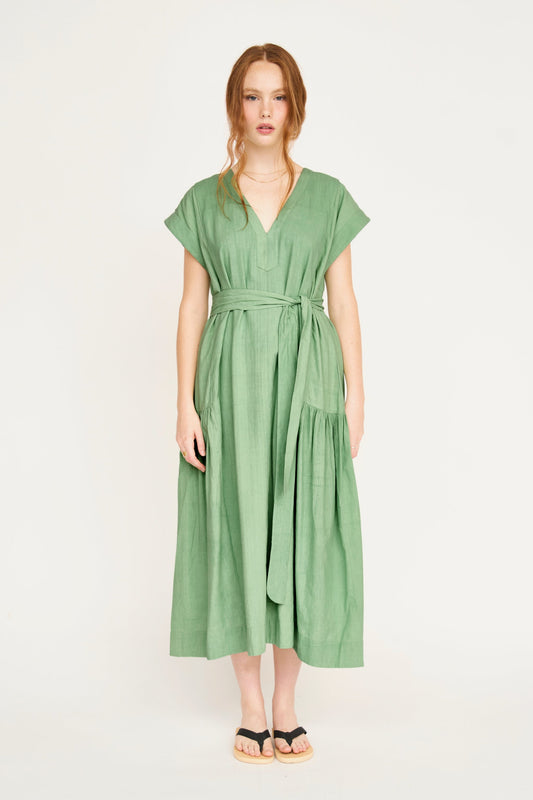 Green cotton midi dress on a hanger in store