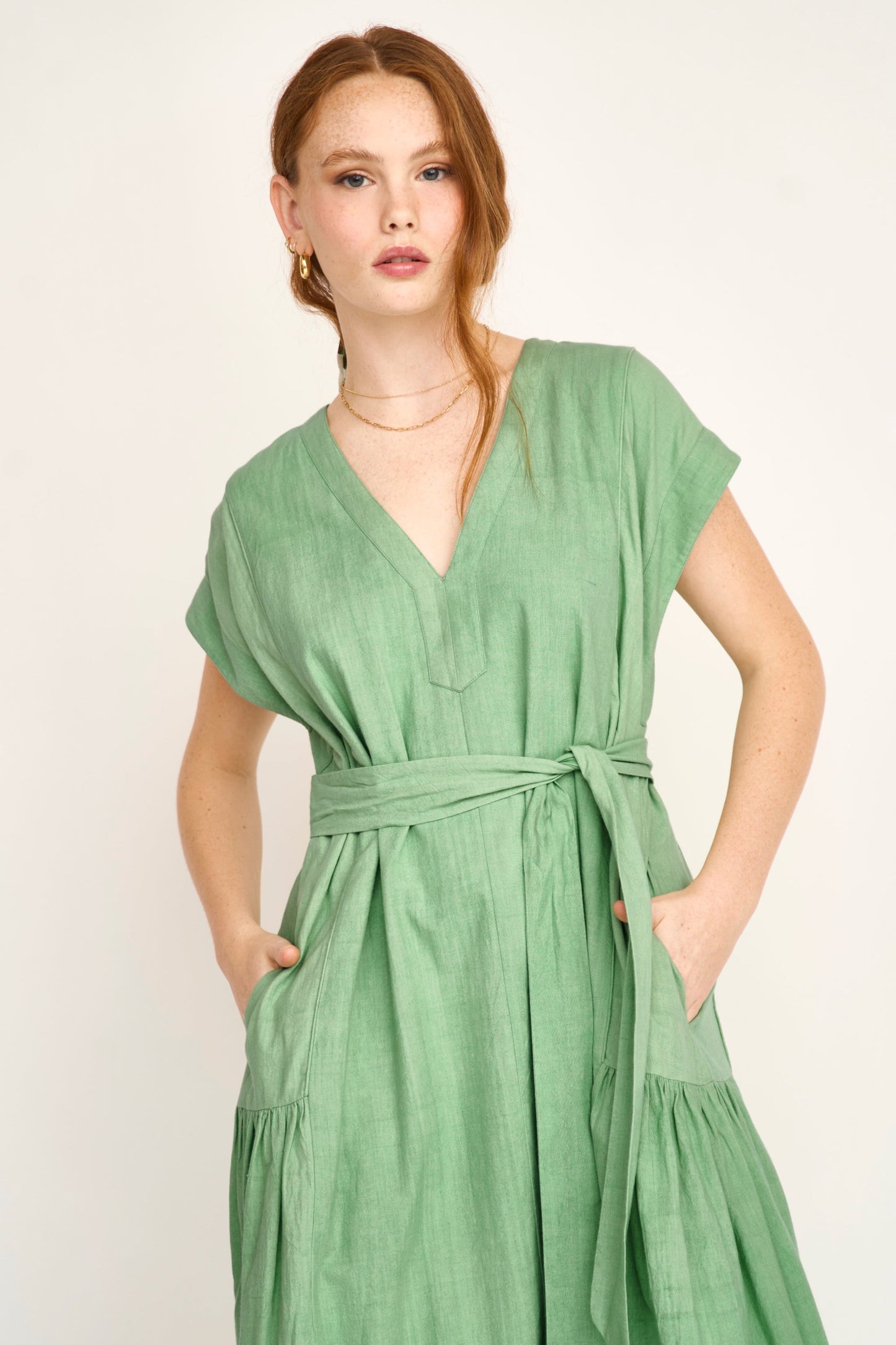 Green cotton midi dress on a hanger in store