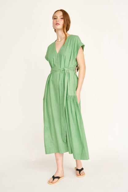 Green cotton midi dress on a hanger in store