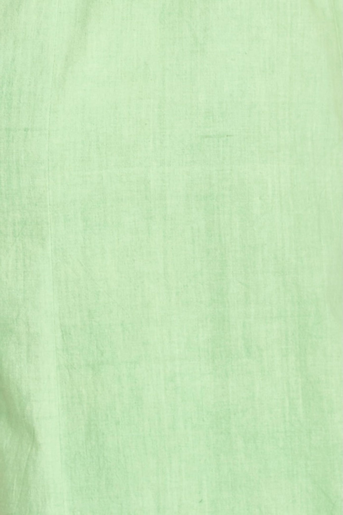 Green cotton midi dress on a hanger in store