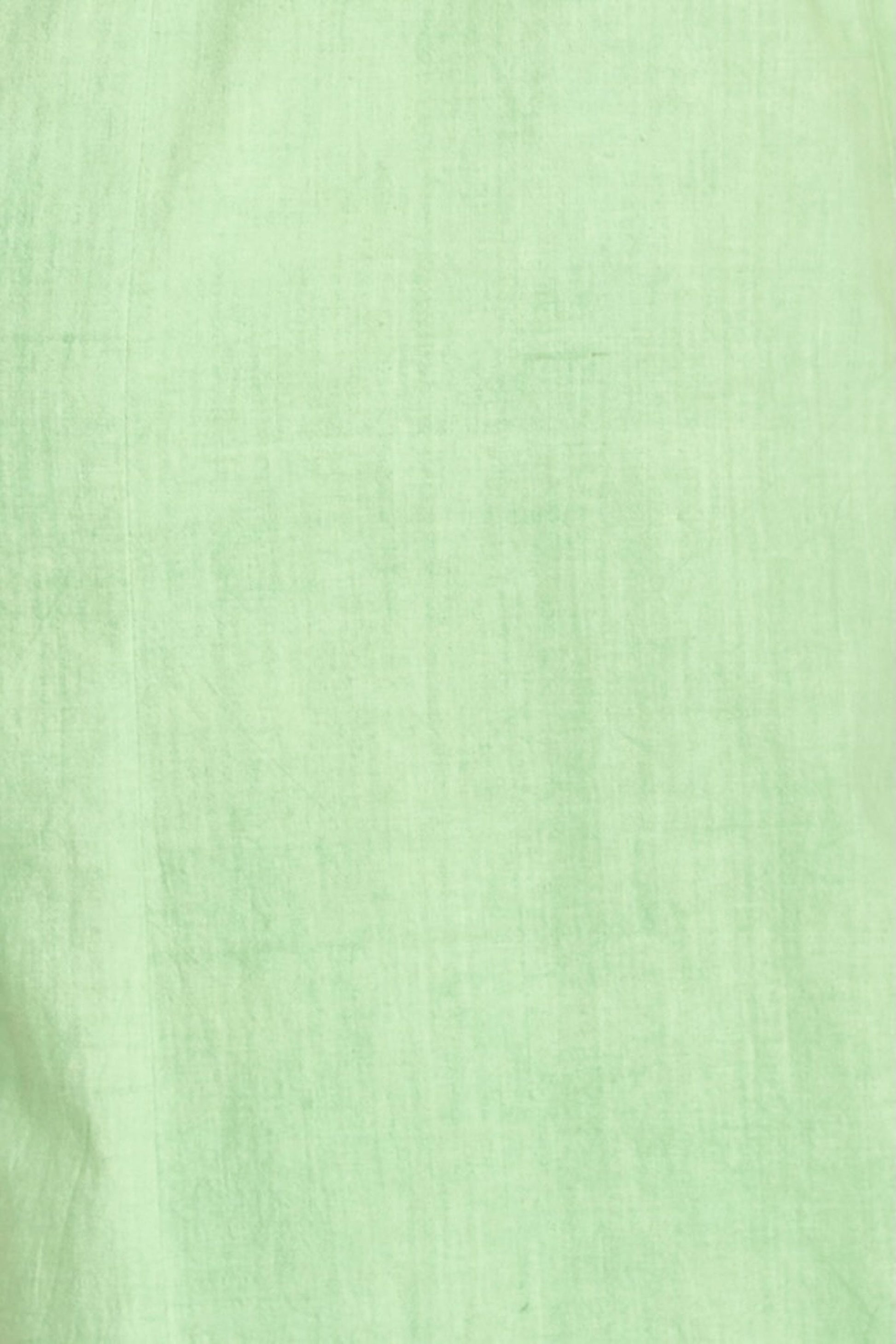 Green cotton midi dress on a hanger in store