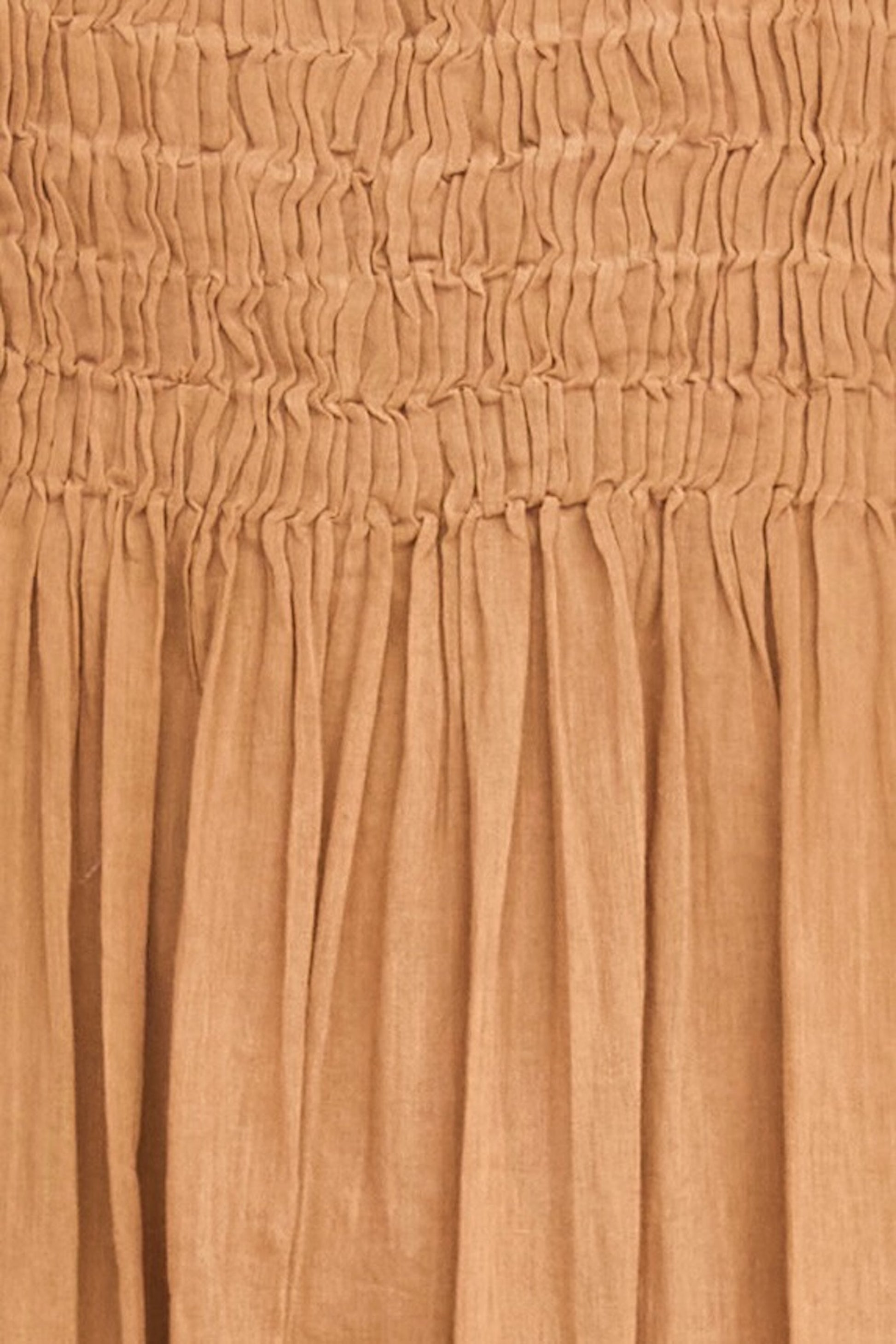 Brown cotton maxi dress on a hanger in store
