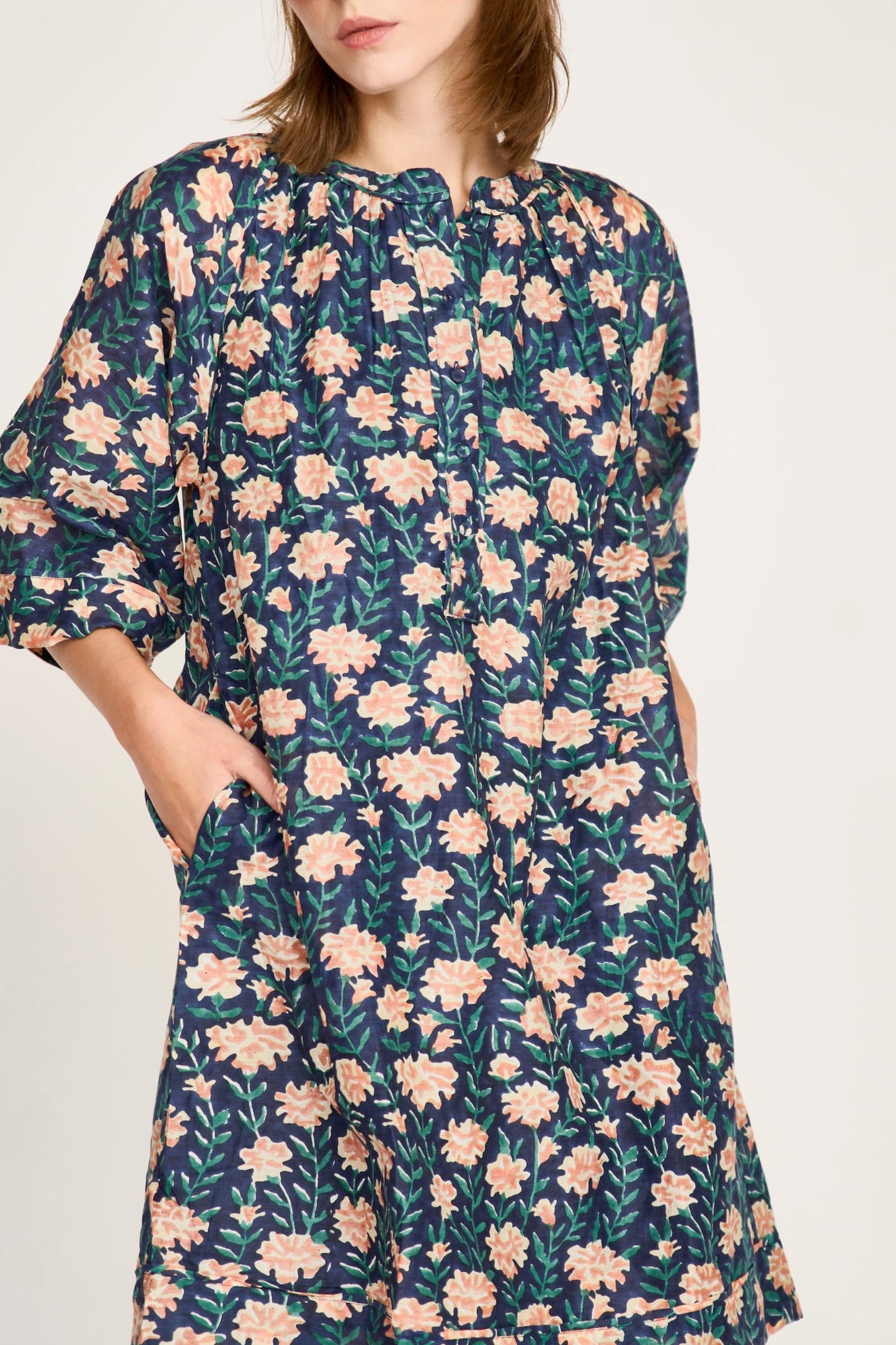 Pink cotton short dress on a hanger in store