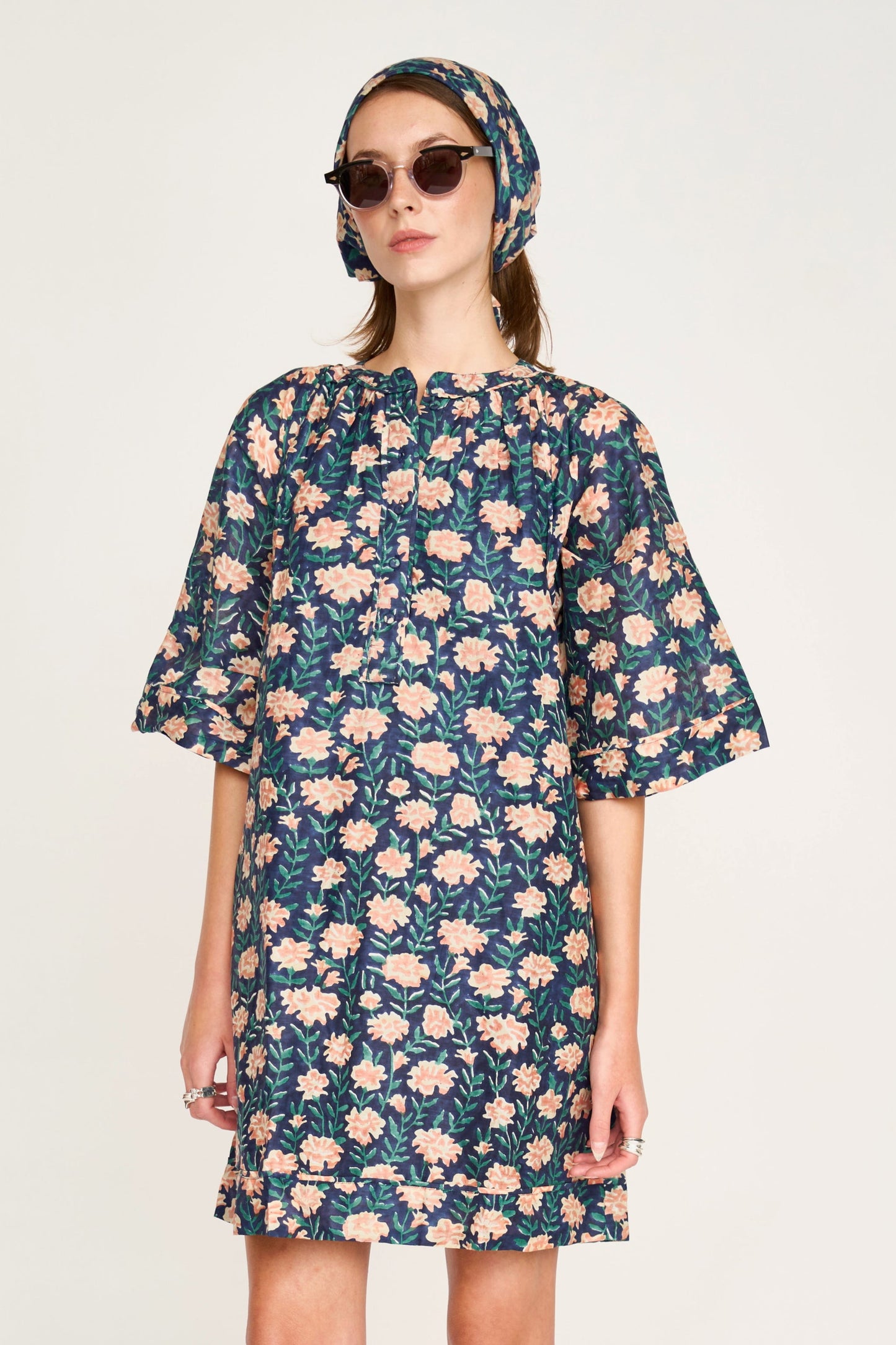 Pink cotton short dress on a hanger in store