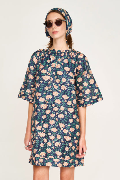 Pink cotton short dress on a hanger in store