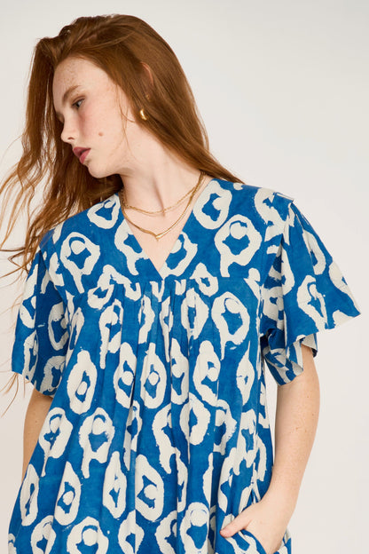 Indigo cotton short dress on a hanger in store