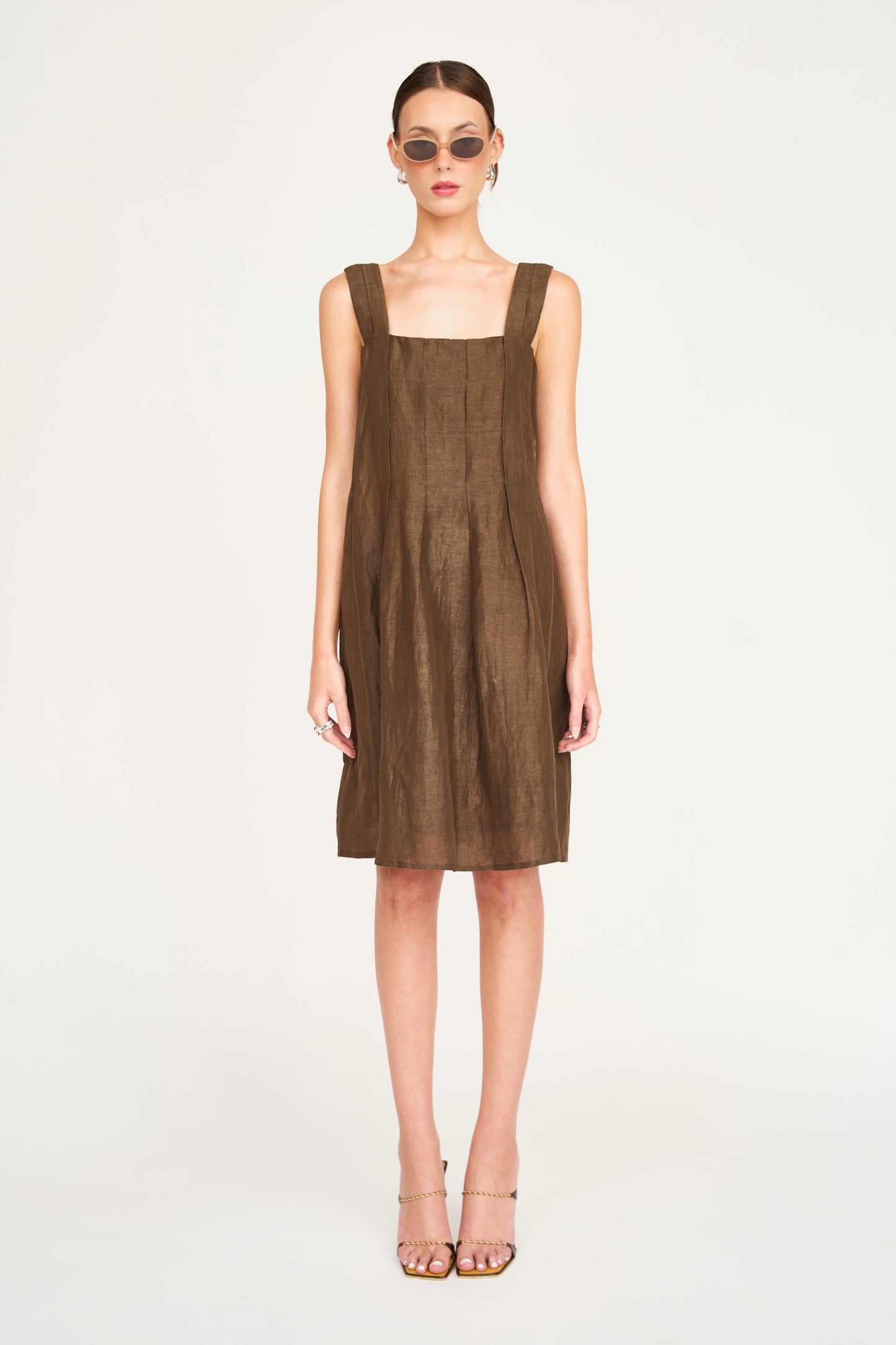 Brown linen short dress on a hanger in store