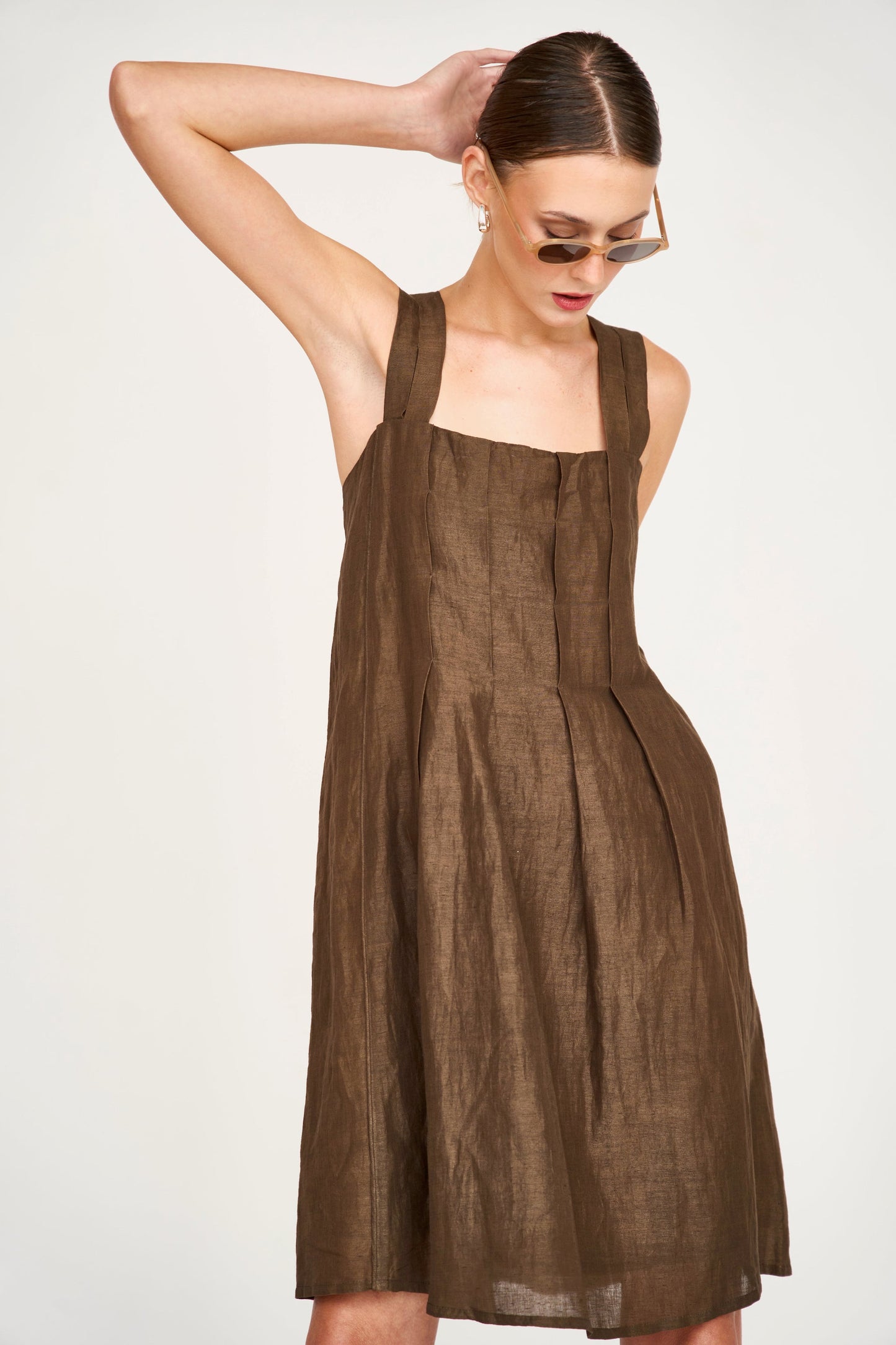 Brown linen short dress on a hanger in store