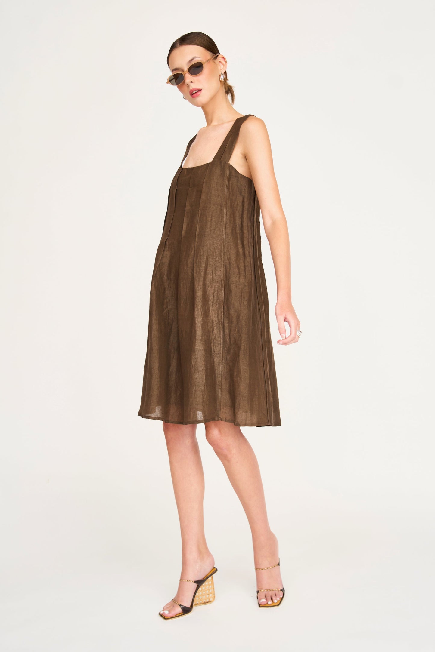 Brown linen short dress on a hanger in store