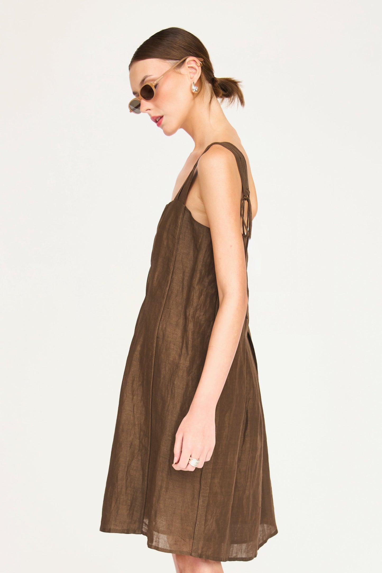 Brown linen short dress on a hanger in store