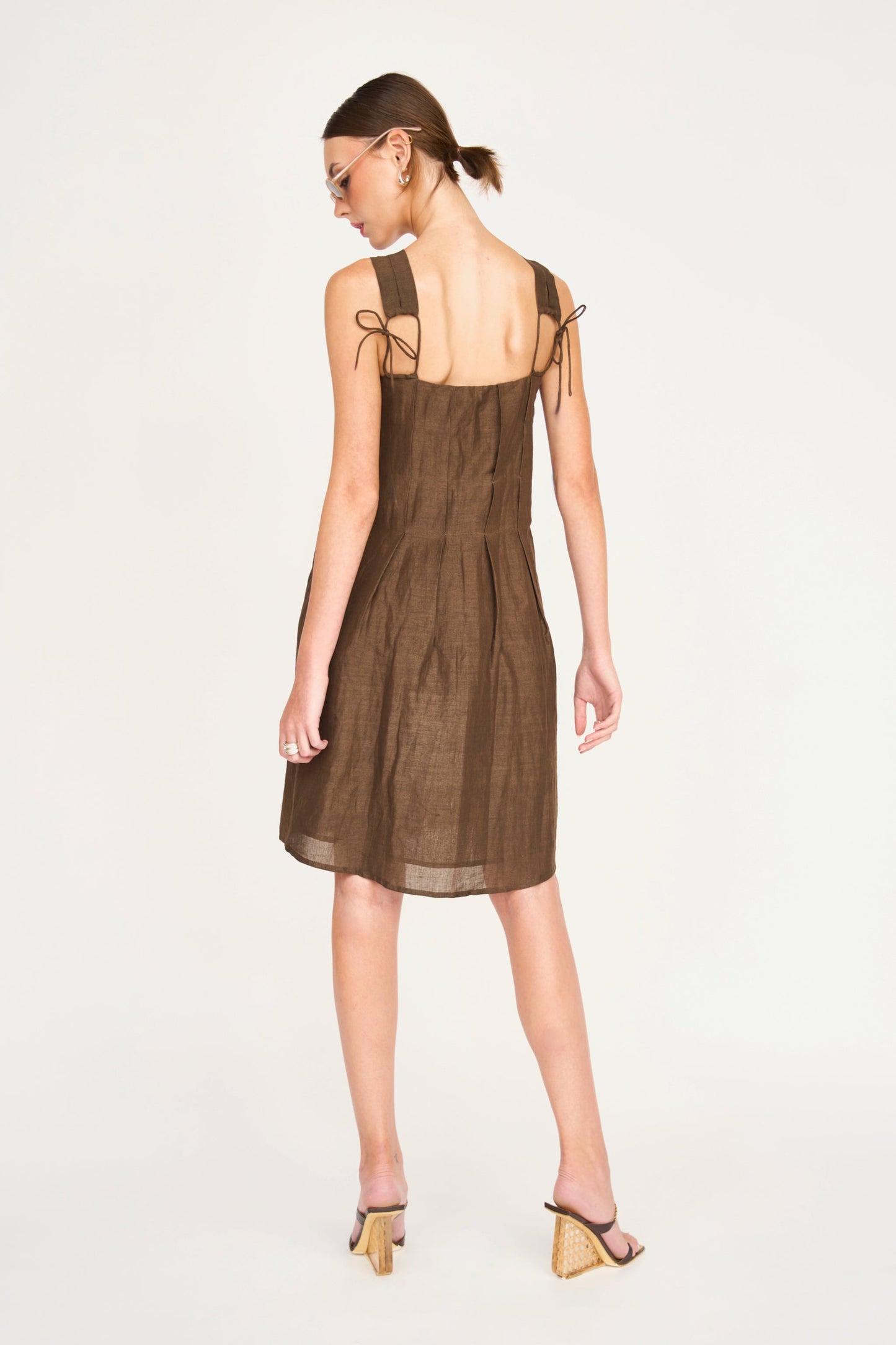 Brown linen short dress on a hanger in store