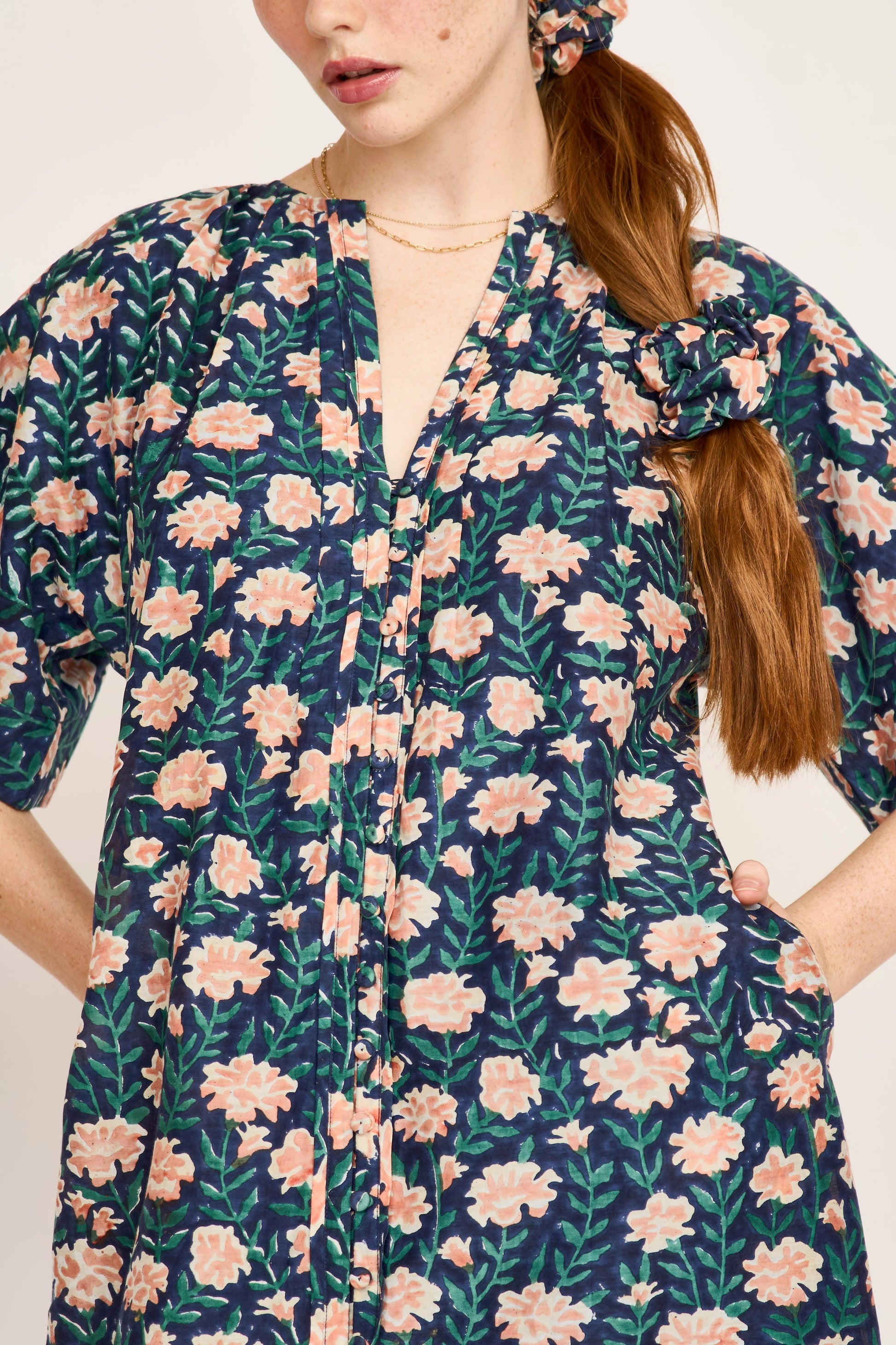 Pink cotton maxi dress on a hanger in store