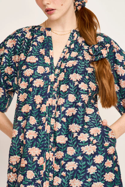 Pink cotton maxi dress on a hanger in store