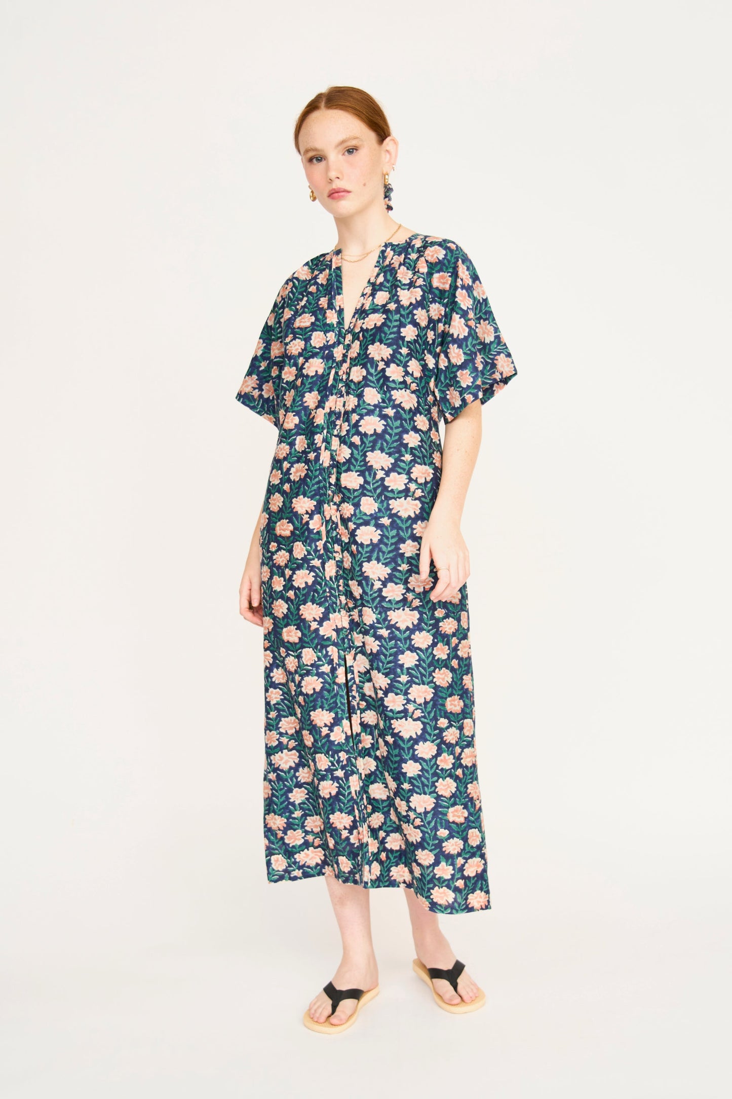 Pink cotton maxi dress on a hanger in store