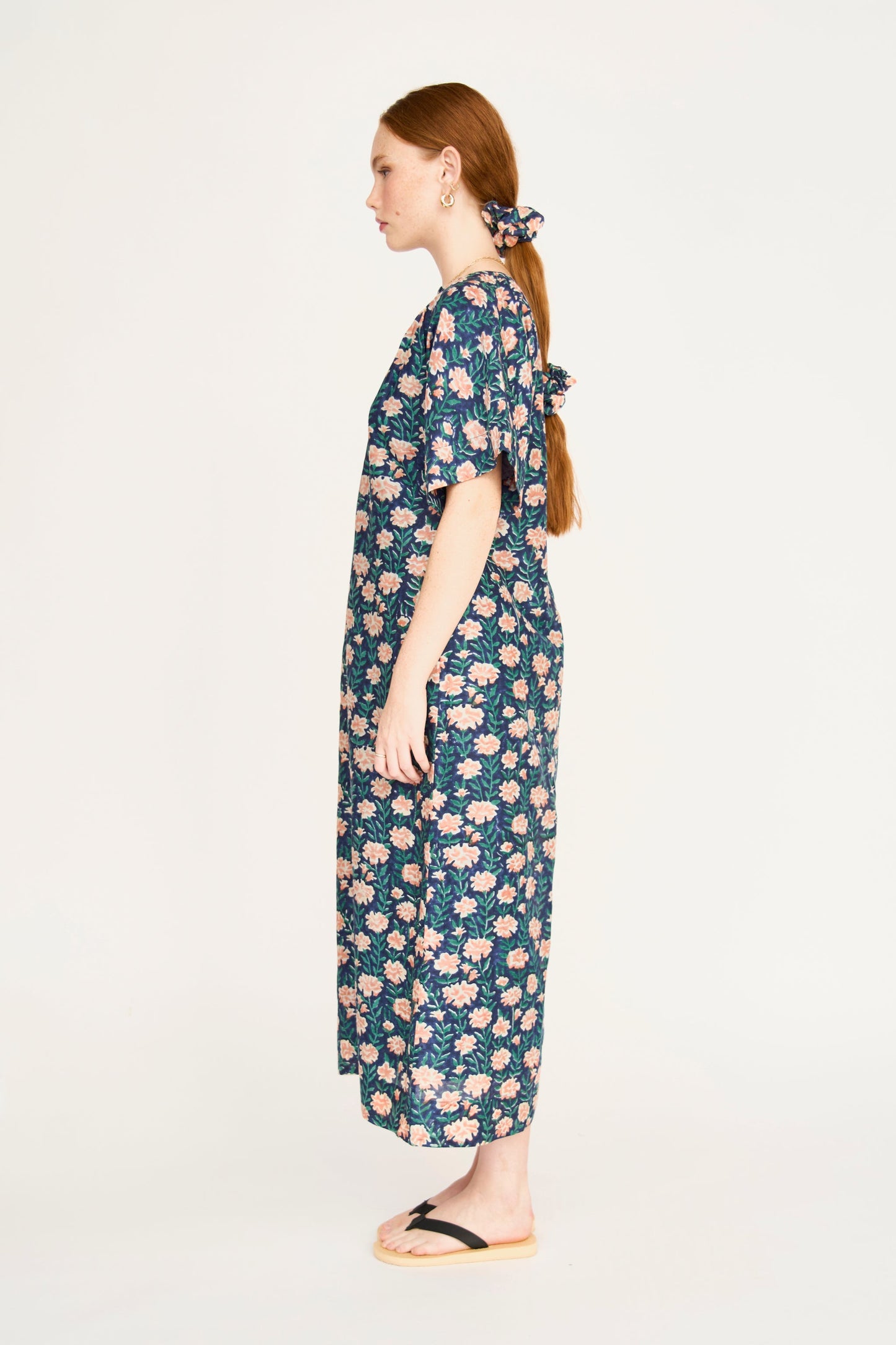Pink cotton maxi dress on a hanger in store
