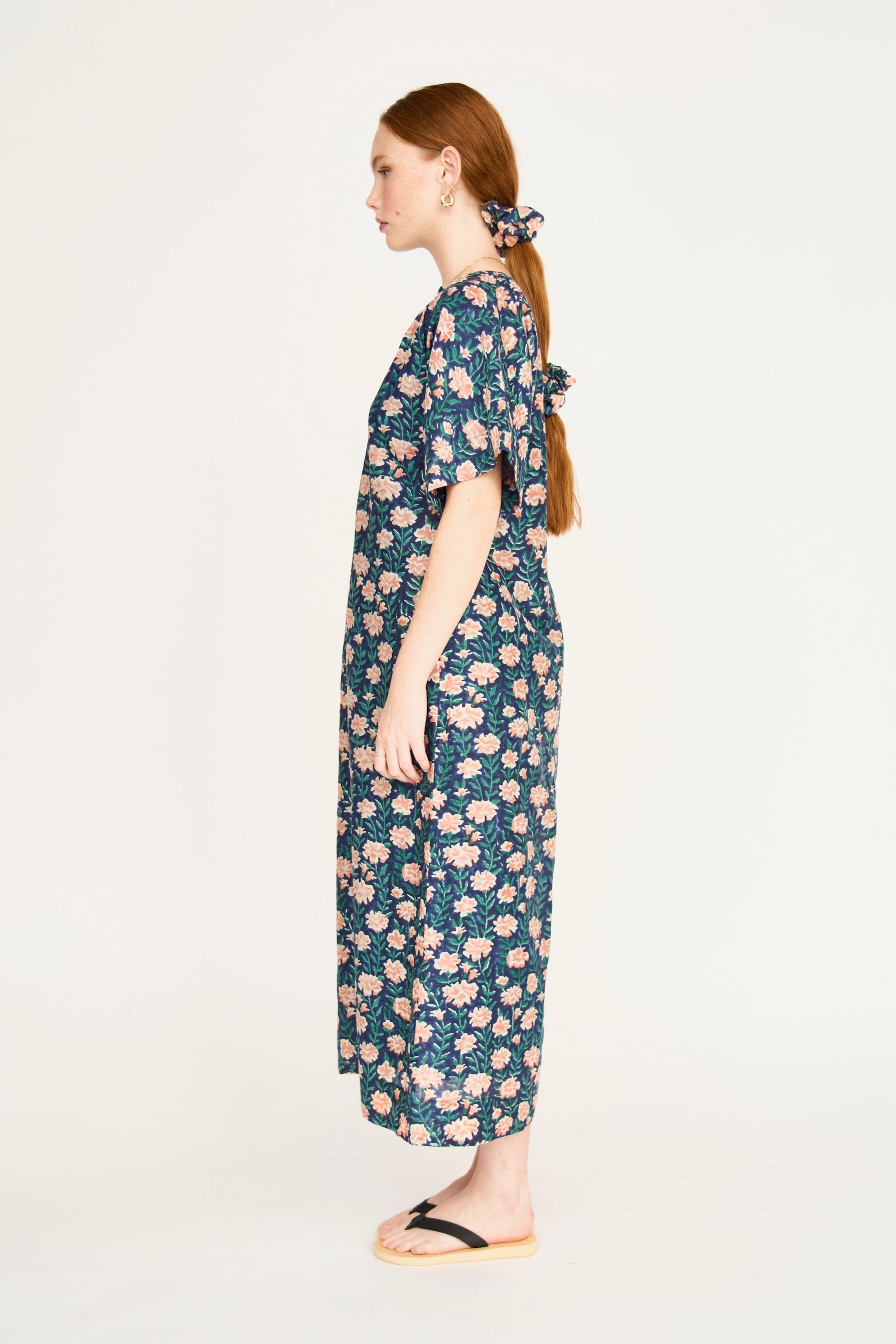 Pink cotton maxi dress on a hanger in store