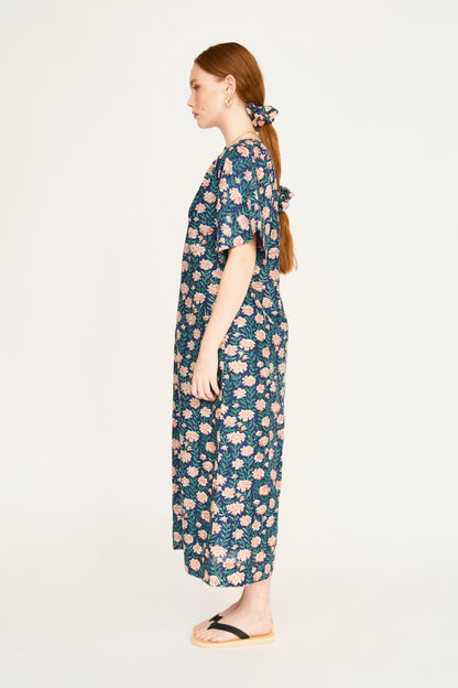 Pink cotton maxi dress on a hanger in store