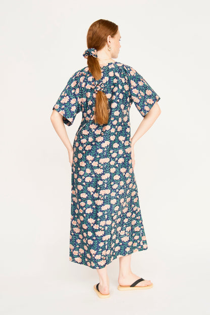 Pink cotton maxi dress on a hanger in store