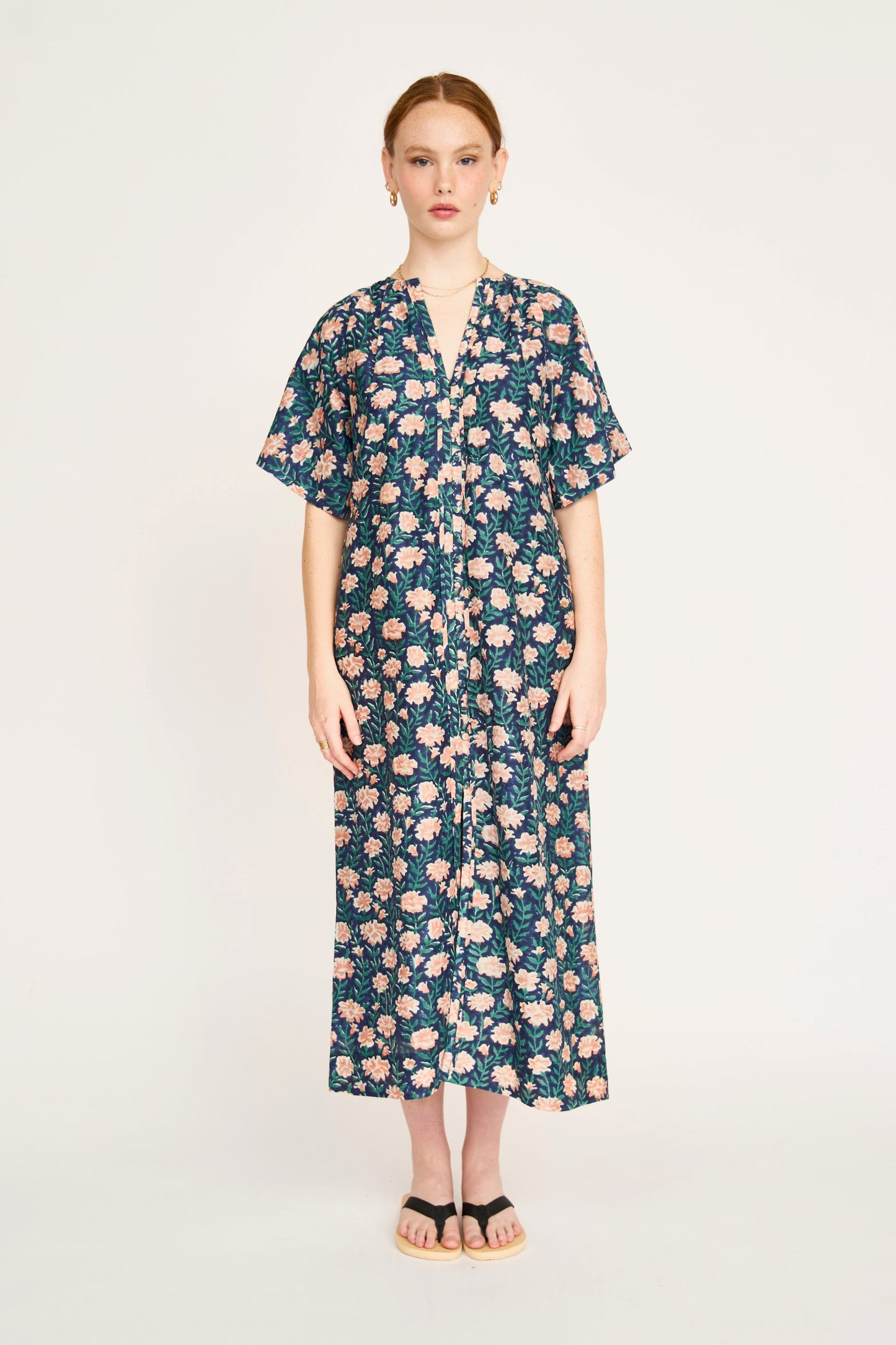 Pink cotton maxi dress on a hanger in store