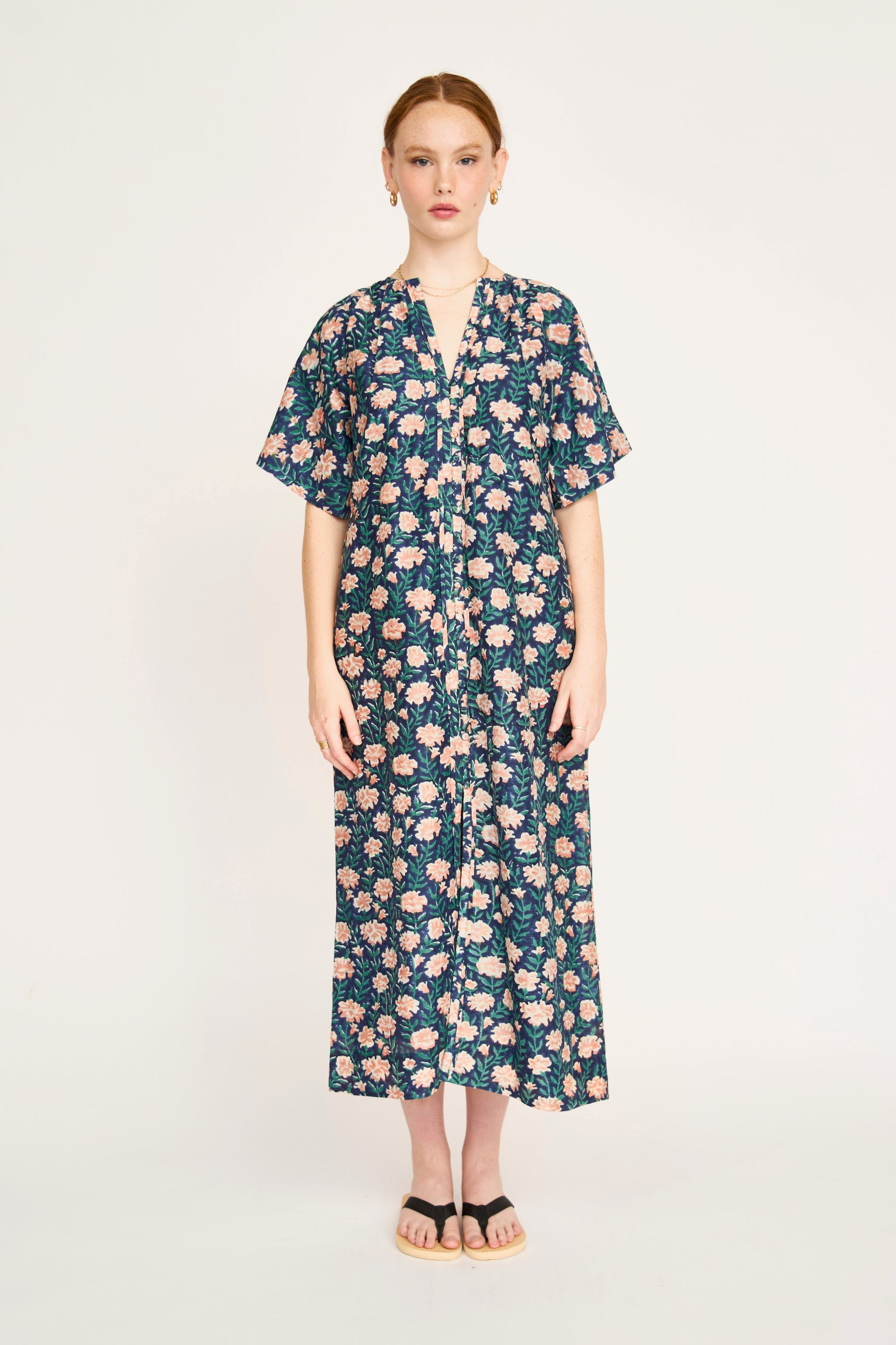 Pink cotton maxi dress on a hanger in store