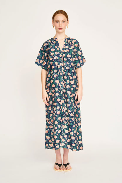 Pink cotton maxi dress on a hanger in store