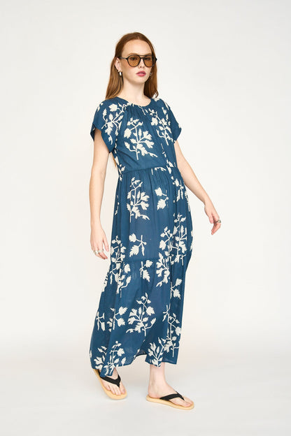 Blue cotton maxi dress on a hanger in store