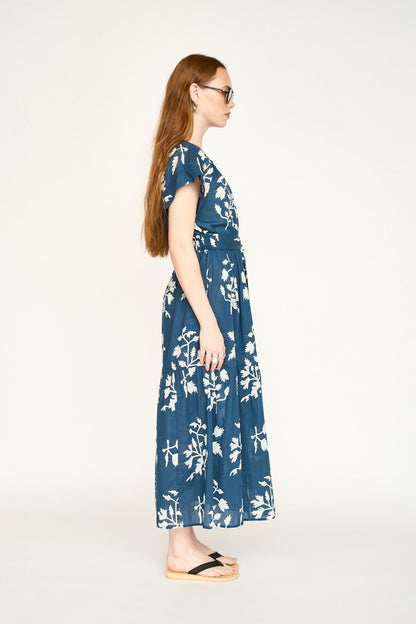 Blue cotton maxi dress on a hanger in store