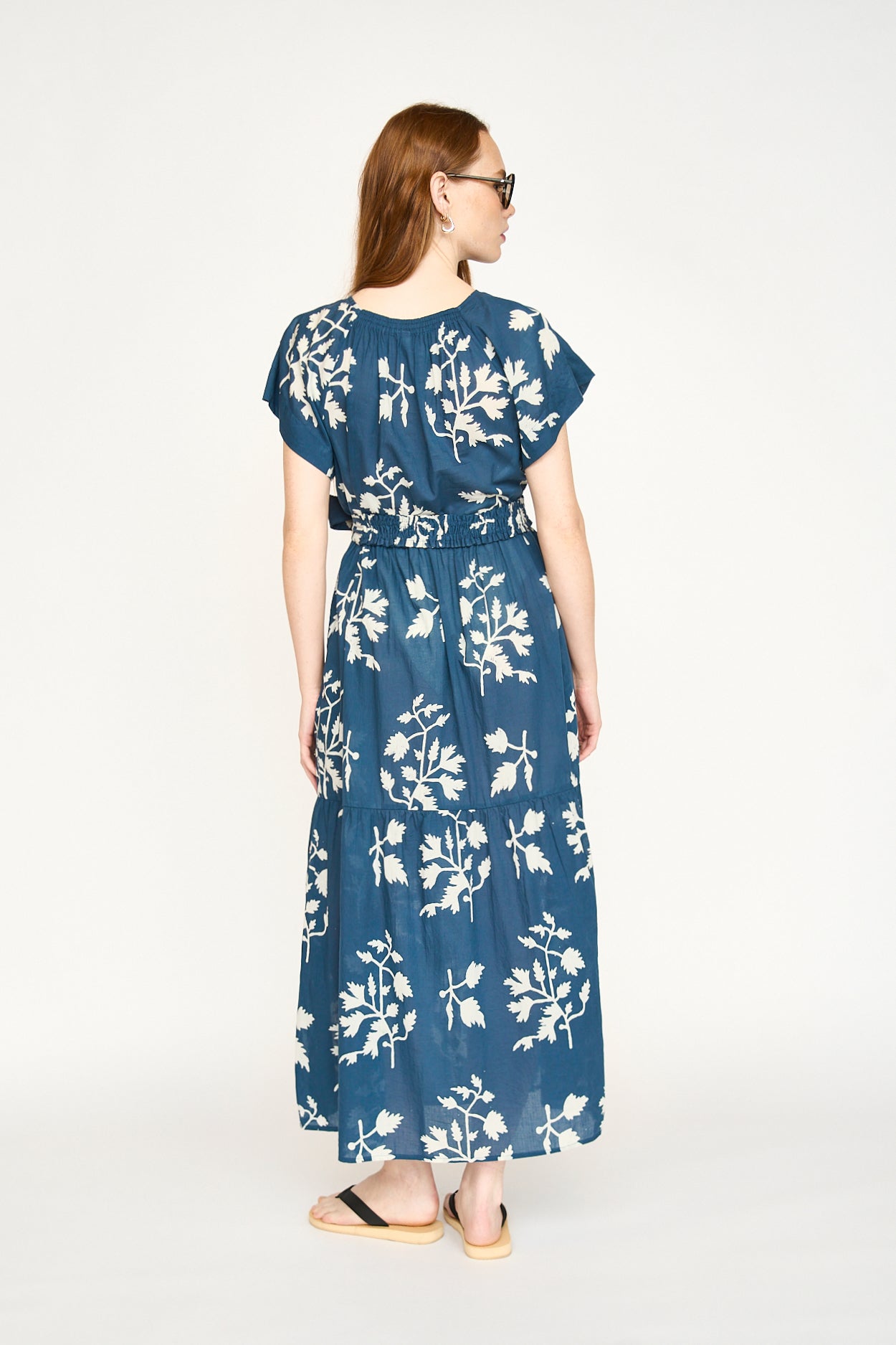 Blue cotton maxi dress on a hanger in store